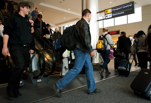 International air travelers entering the United States head to 'Passport Control' inside the US Customs and Immigration area.